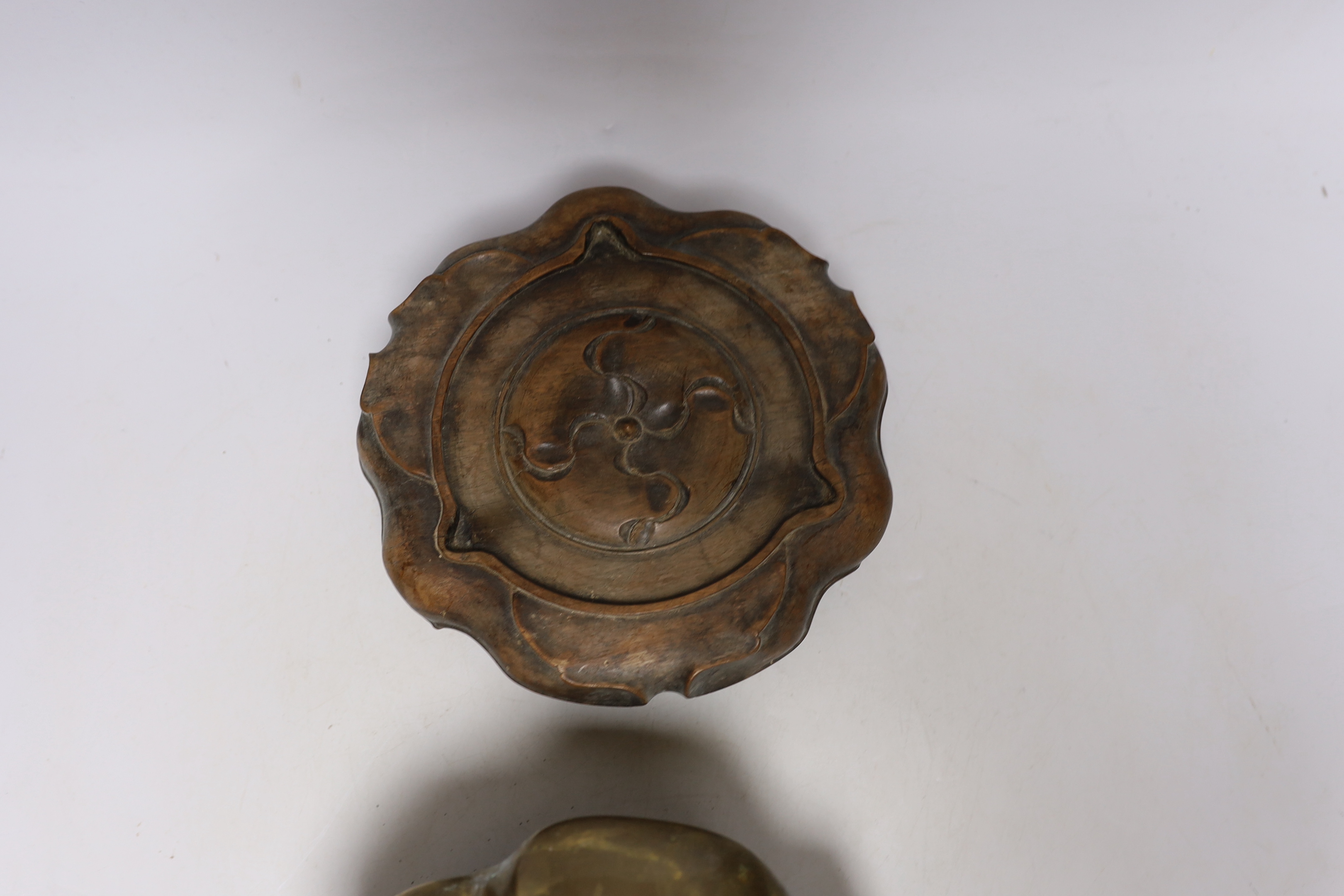 A Chinese bronze tripod censer with twin handles on hardwood stand, censer 19cm wide